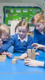 A group of primary school children playing with blocks